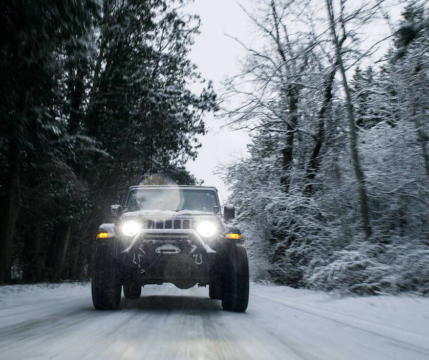 suv driving on icy road